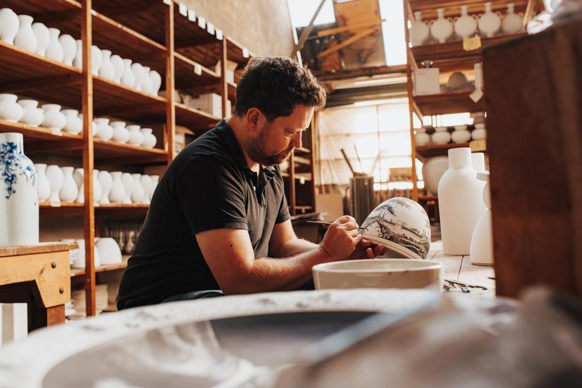 a man is working in a pottery workshop