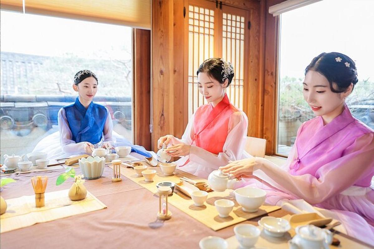 a group of three women sitting around a table with pottery
