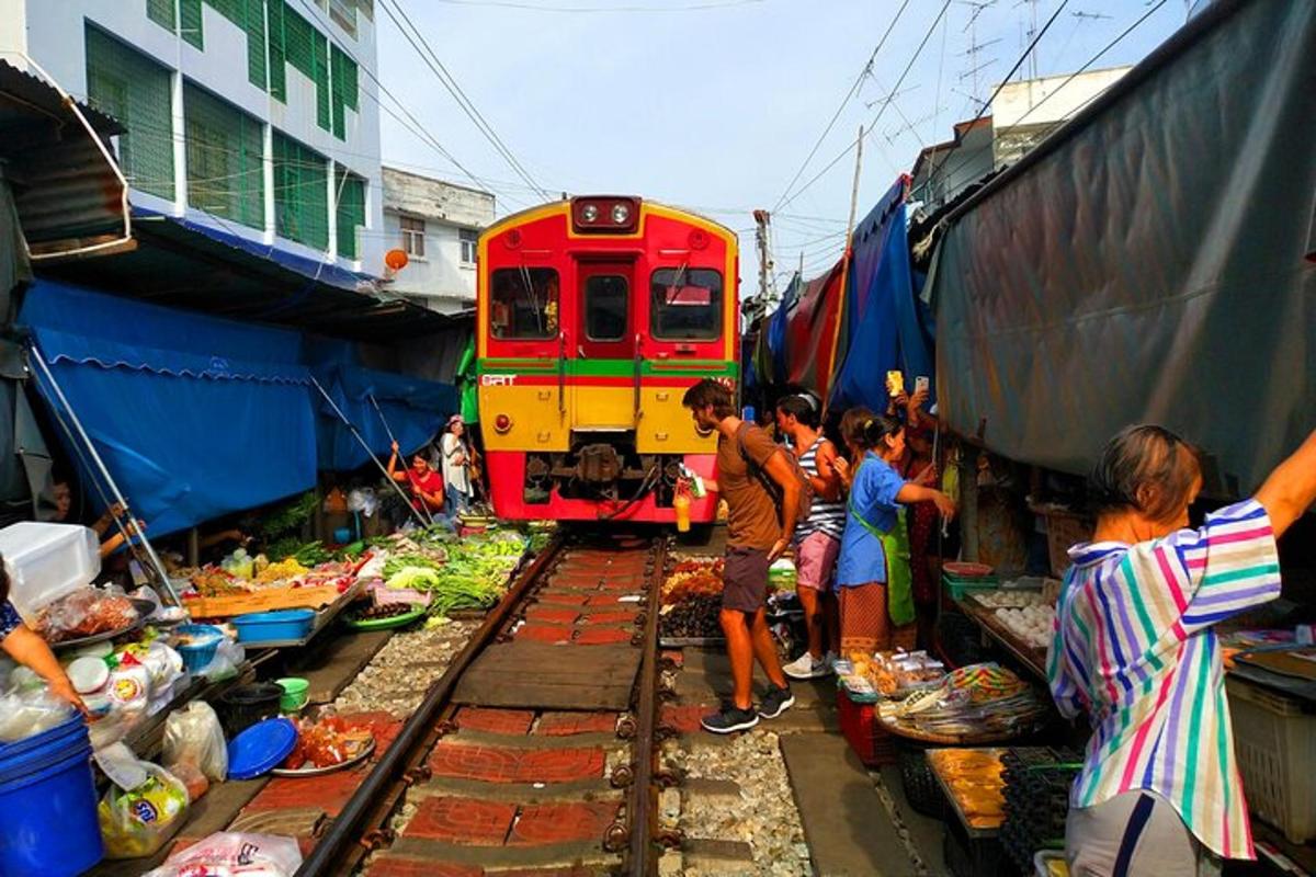 a group of people standing next to a train