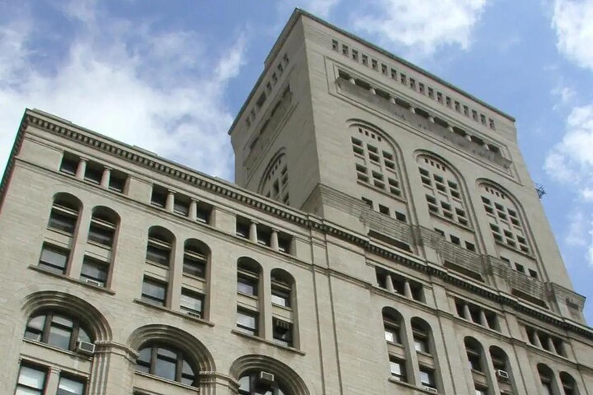 a tall white building with windows on top of it