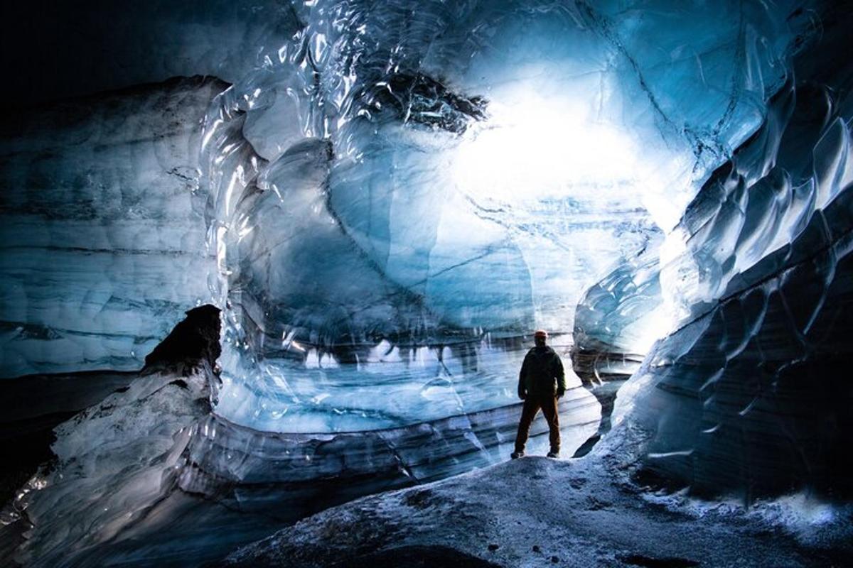 a man is standing in an ice cave