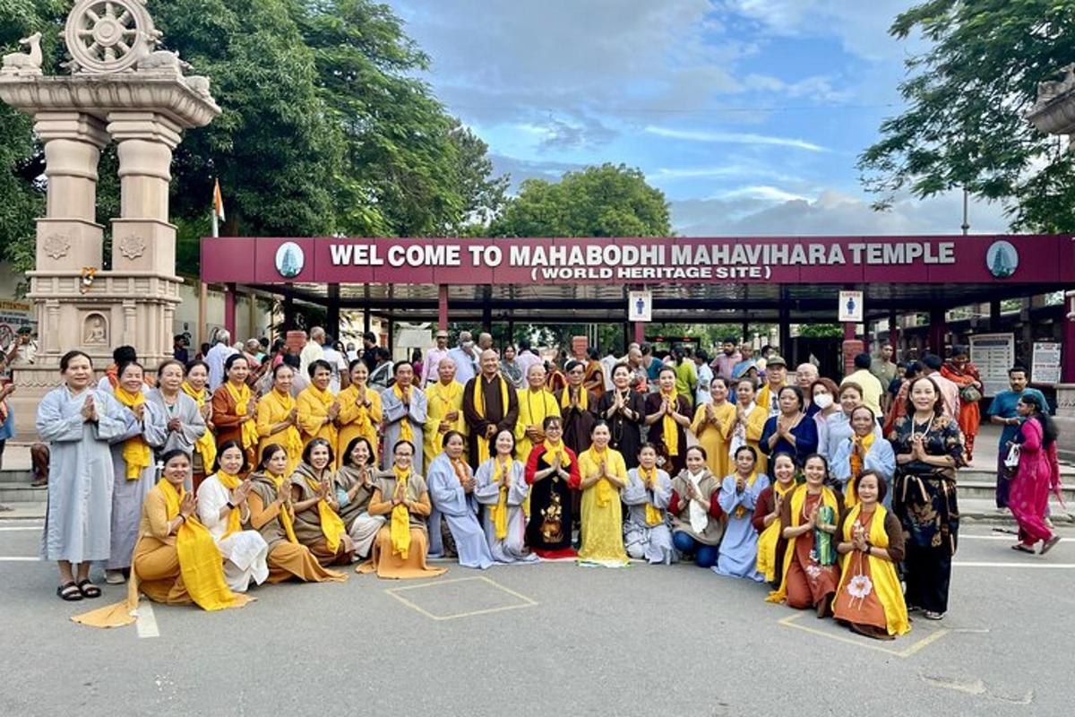 a group of people posing for a picture in front of a building