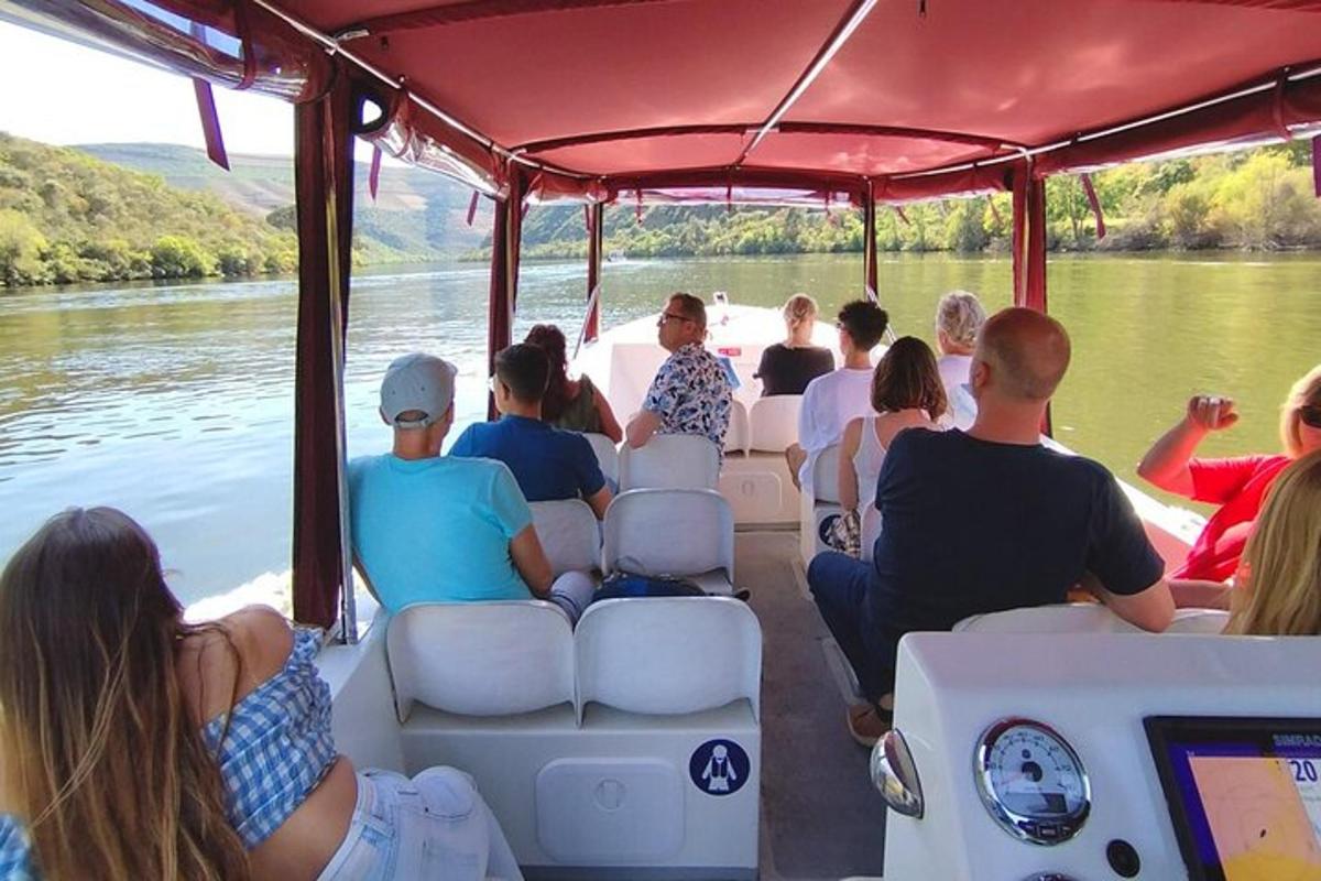 a group of people sitting on a boat on a river