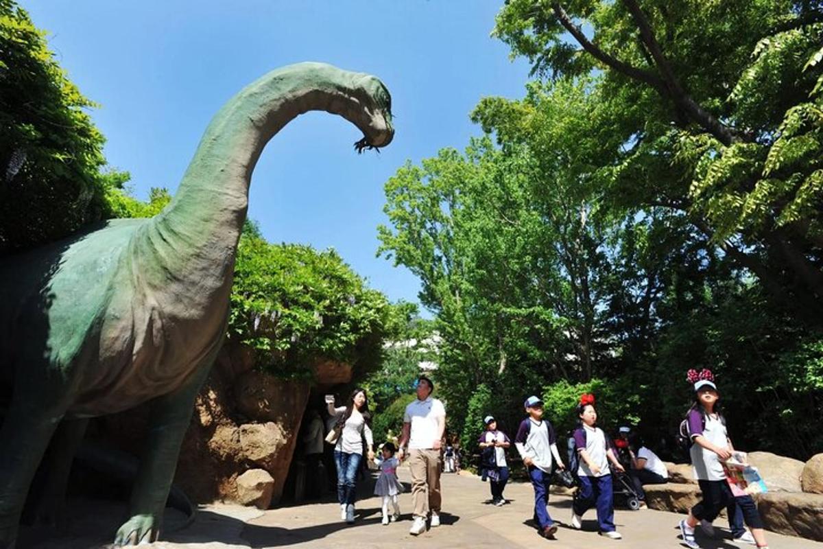 a group of people standing in front of a dinosaur