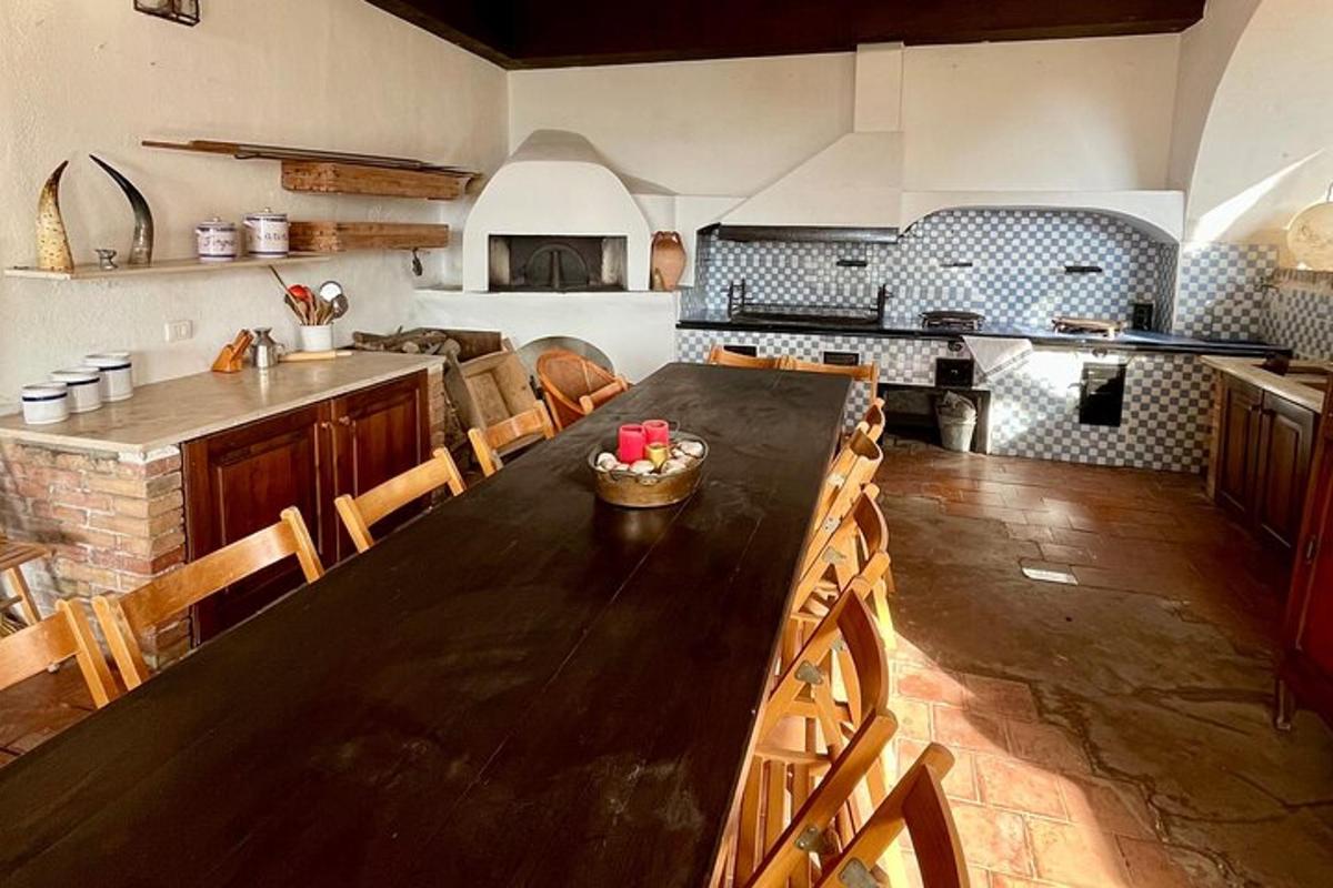uma grande cozinha com uma grande mesa de madeira com cadeiras