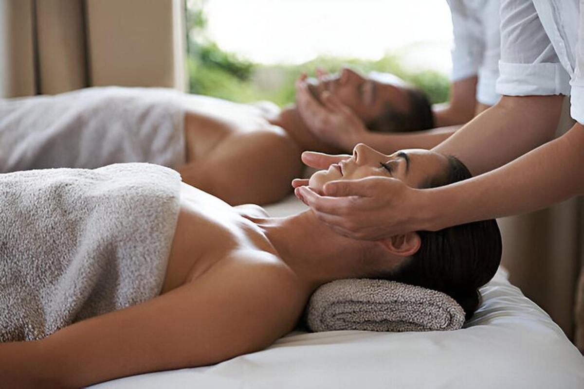 eine Frau, die auf einem Bett liegt und eine Massage bekommt