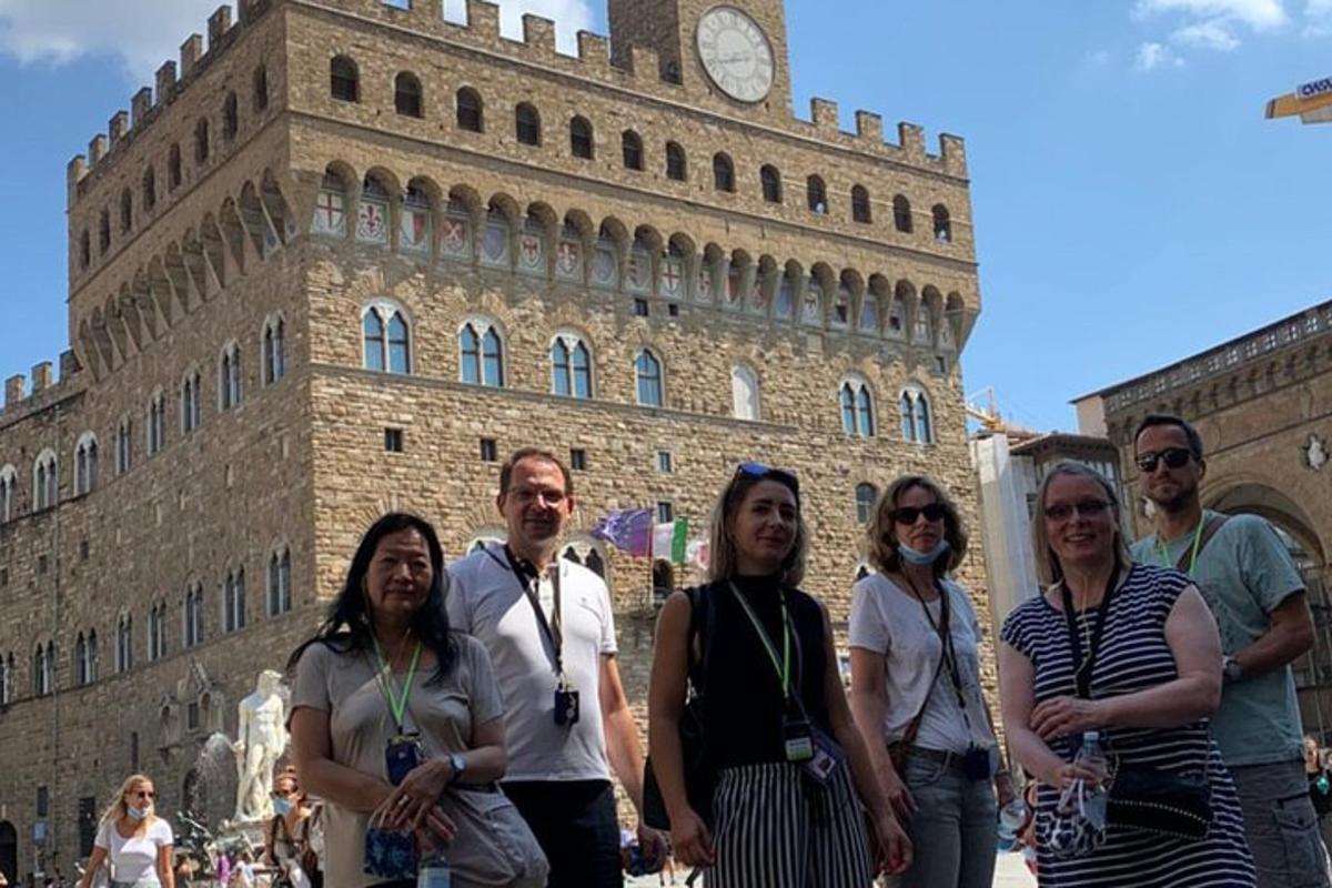 a group of people standing in front of a clock tower