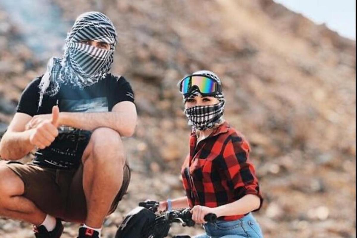 two men withhelmets on their heads and one is giving a thumbs up