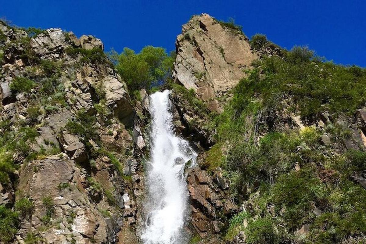 a waterfall on the side of a rocky mountain