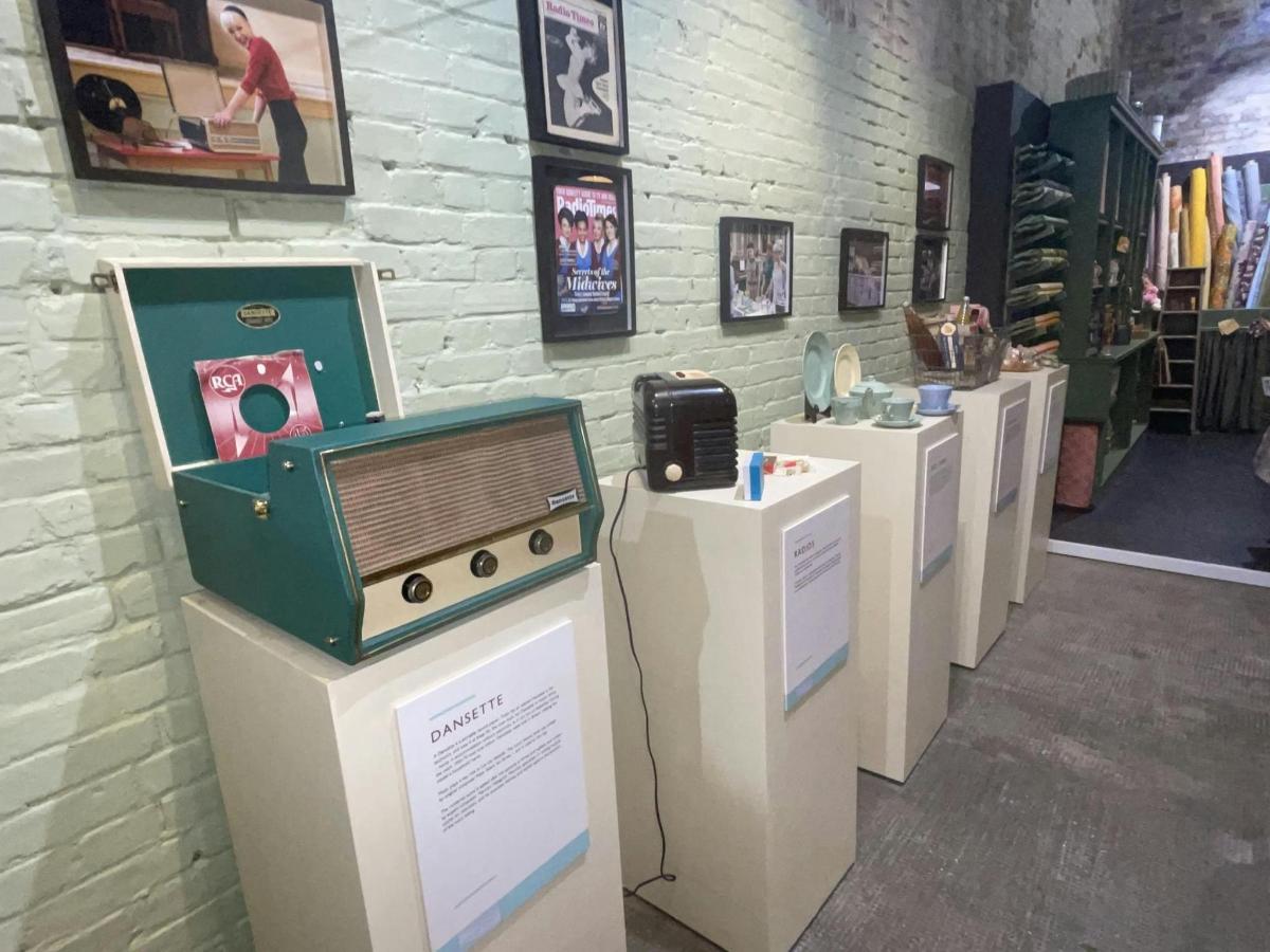 a room with a row of exhibits in a museum