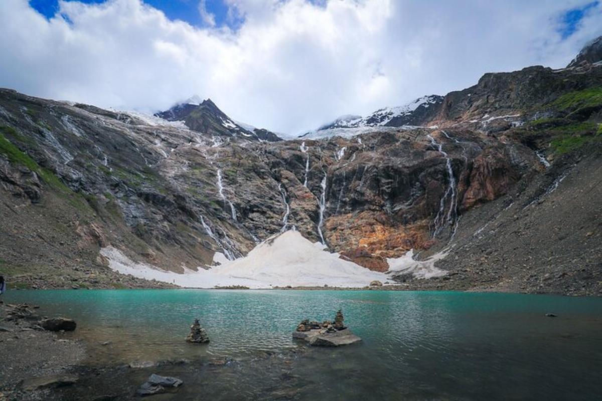 a mountain with a body of water and a waterfall