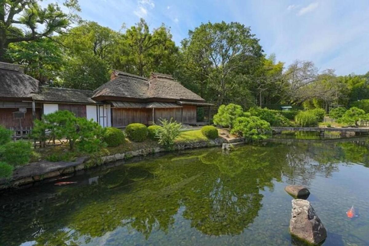 a home with a pond in front of a house