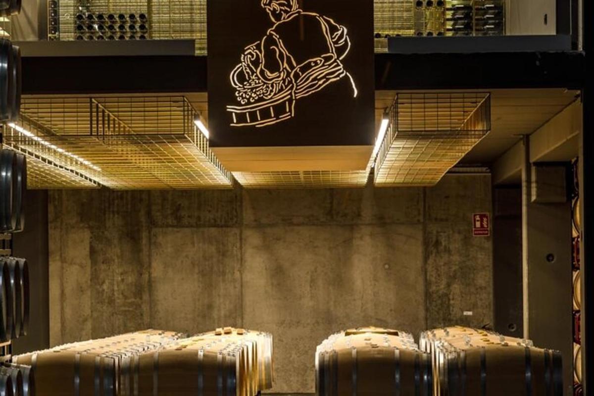 a row of wine barrels in a wine cellar