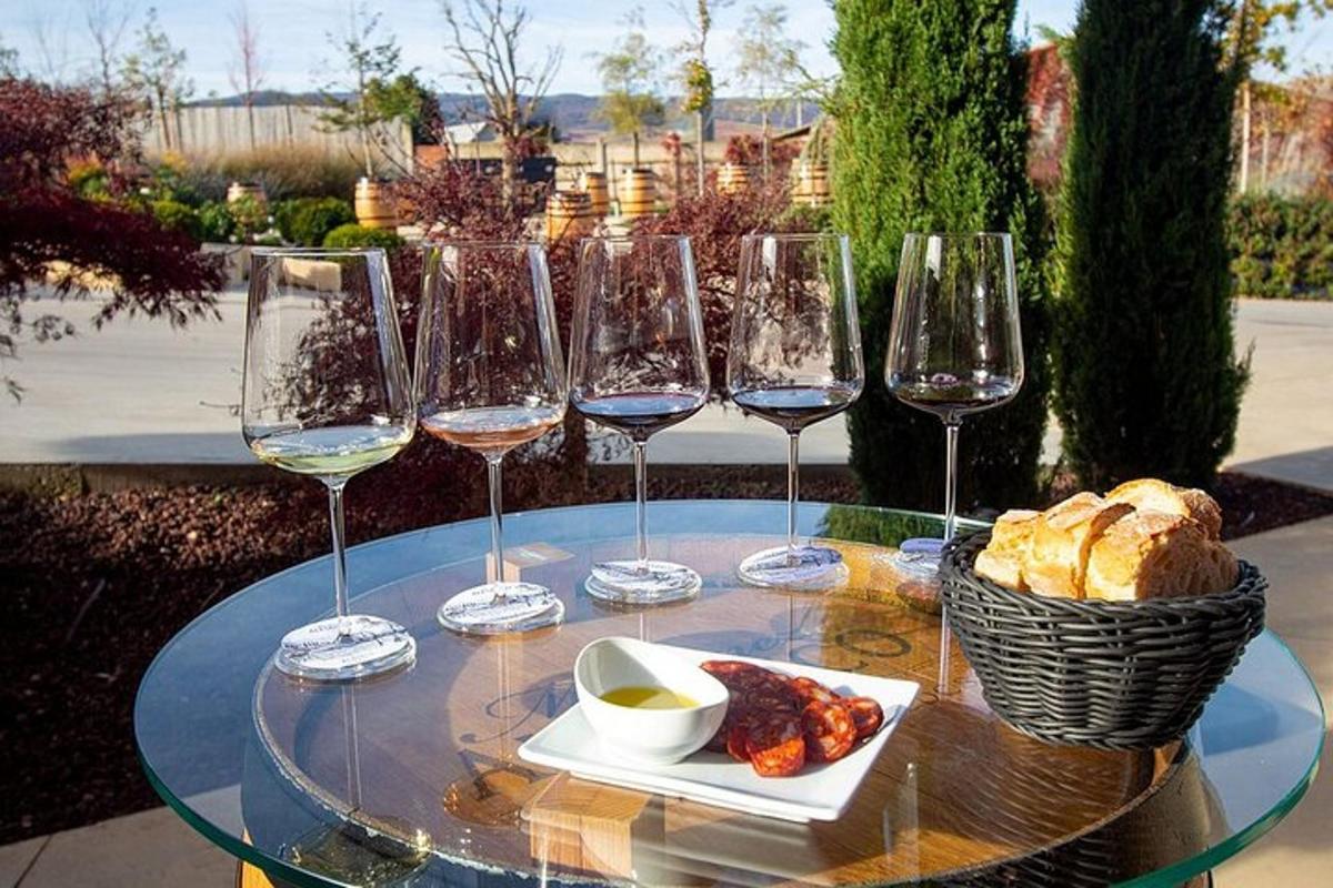 a glass table with wine glasses and a basket of bread