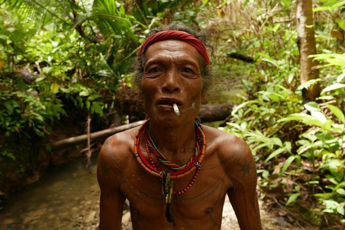 a man with a cigarette in his mouth in the jungle
