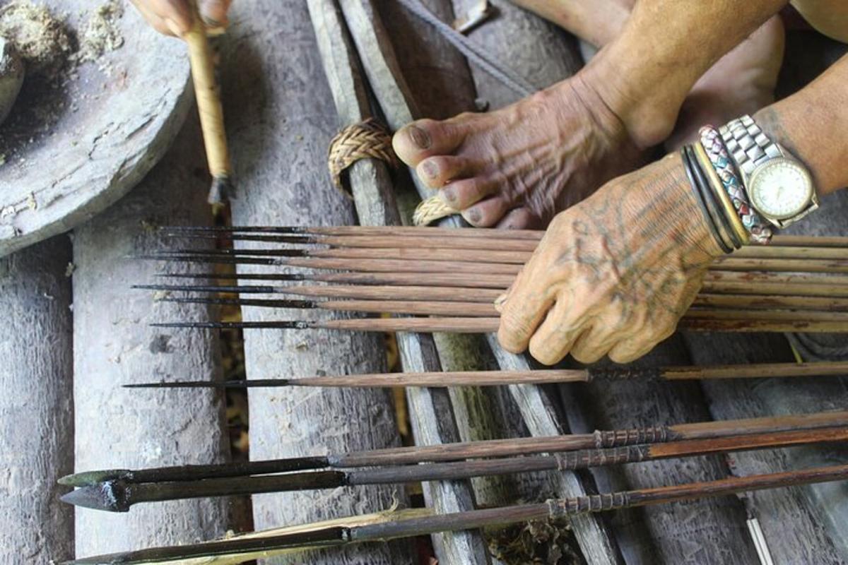 a person is making wooden sticks with their hands