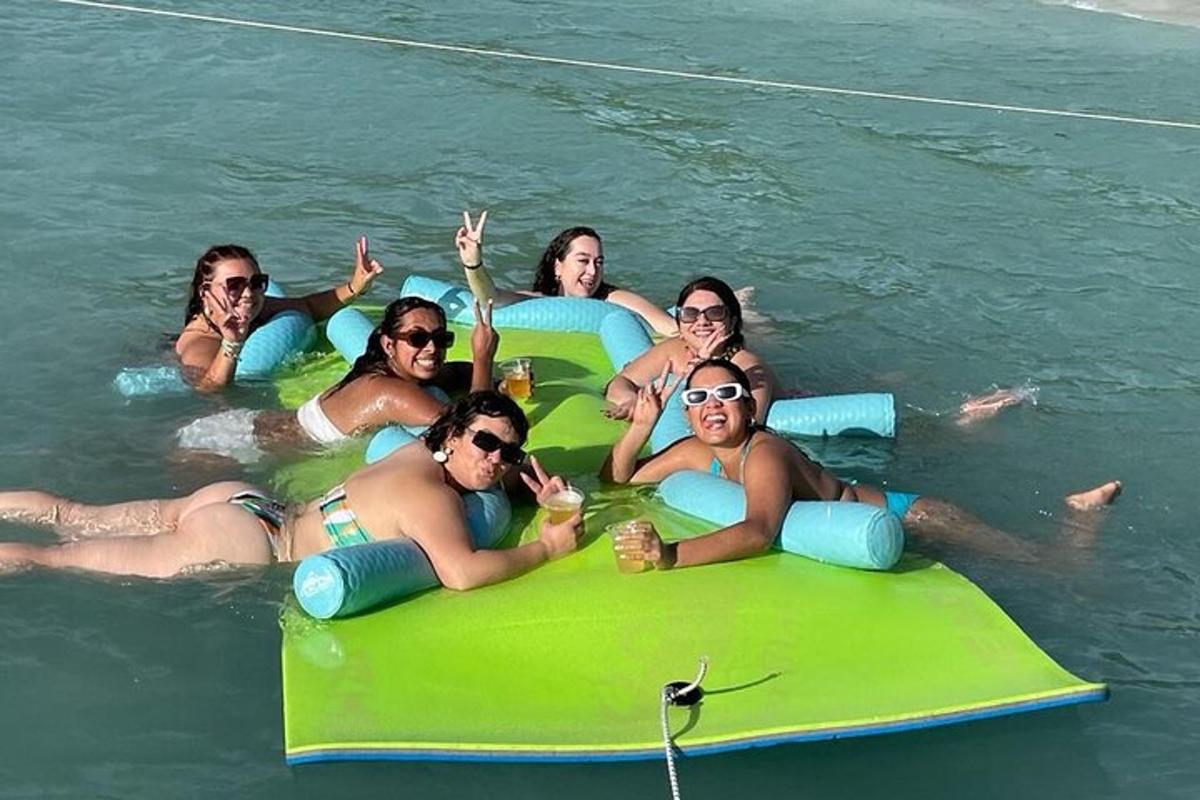 a group of women laying on tubes in the water