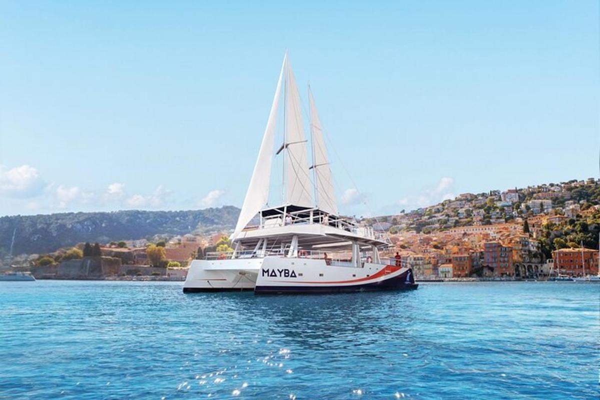 a sailboat in the water with a city in the background