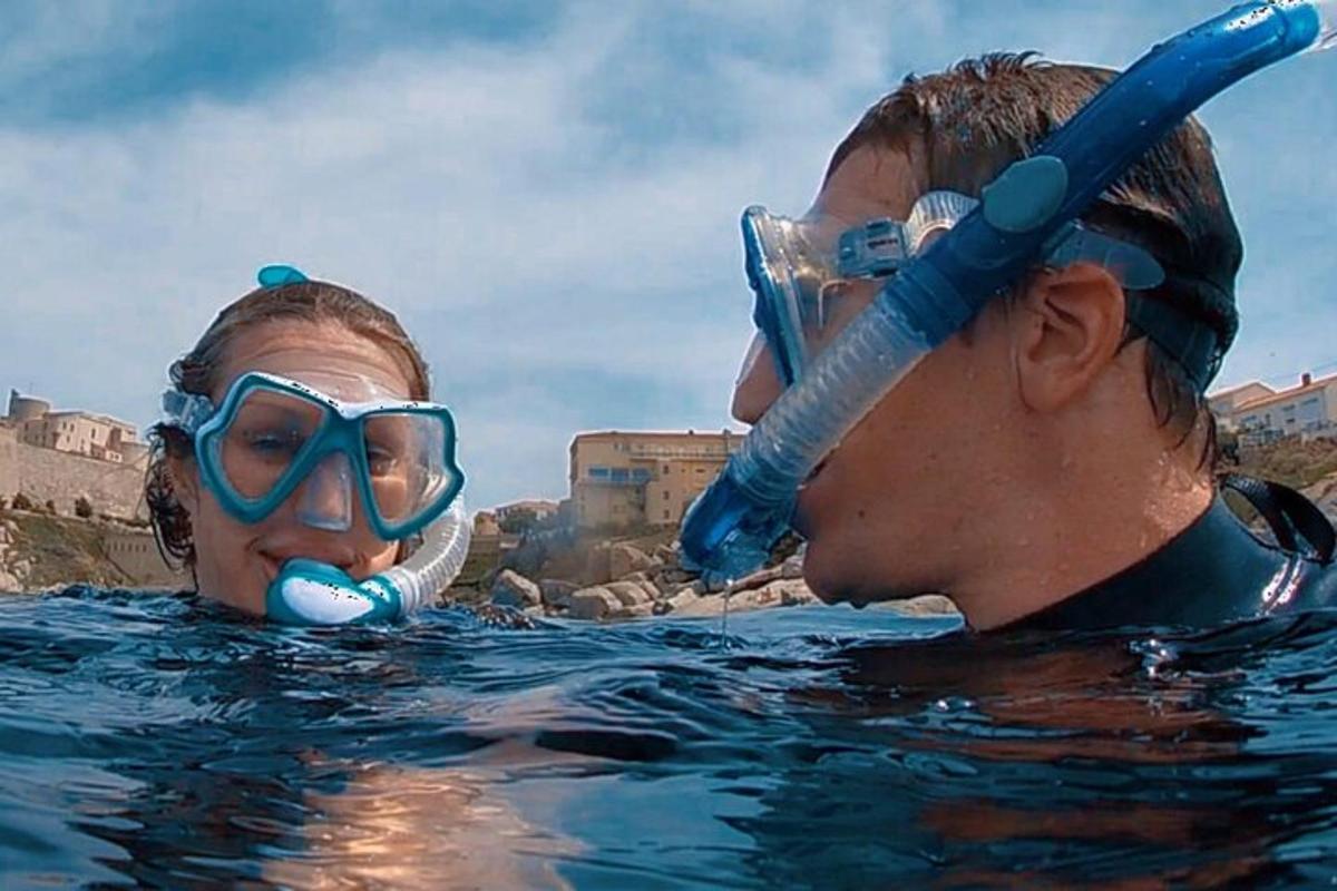 a man and a woman in the water in a swimming pool