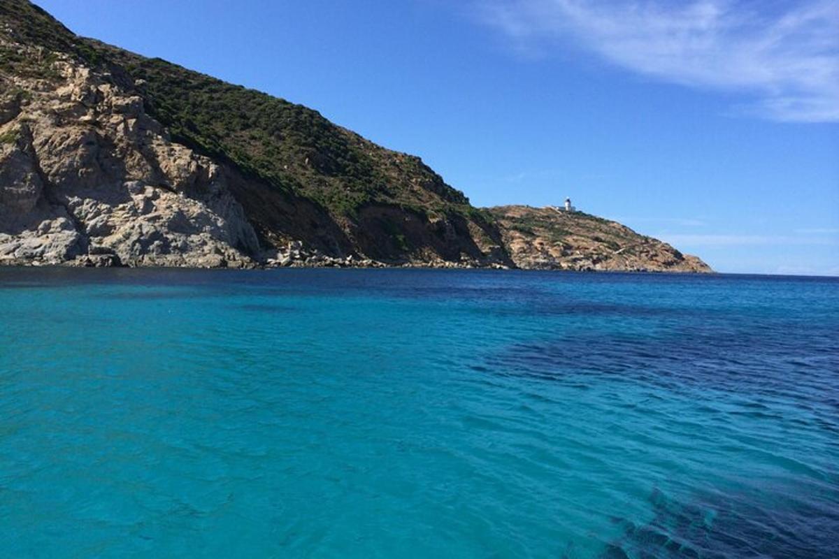 a large body of water next to a mountain