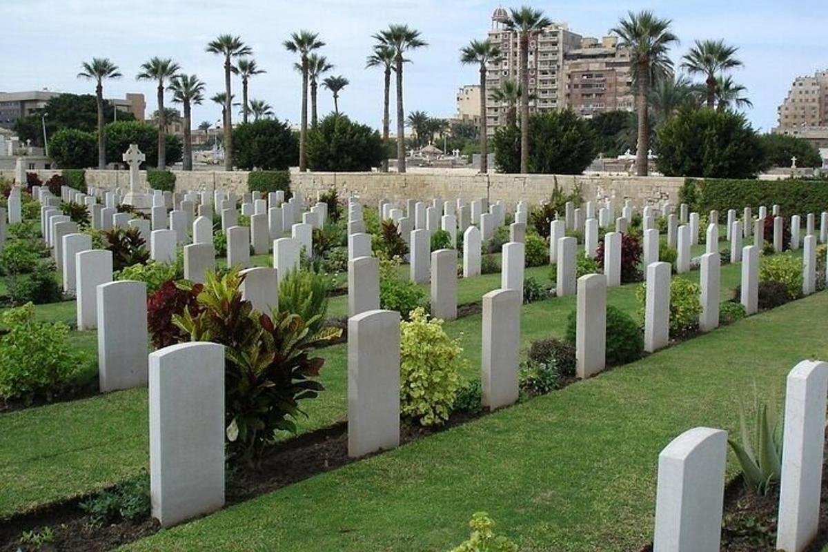 a row of white gravestones in a cemetery