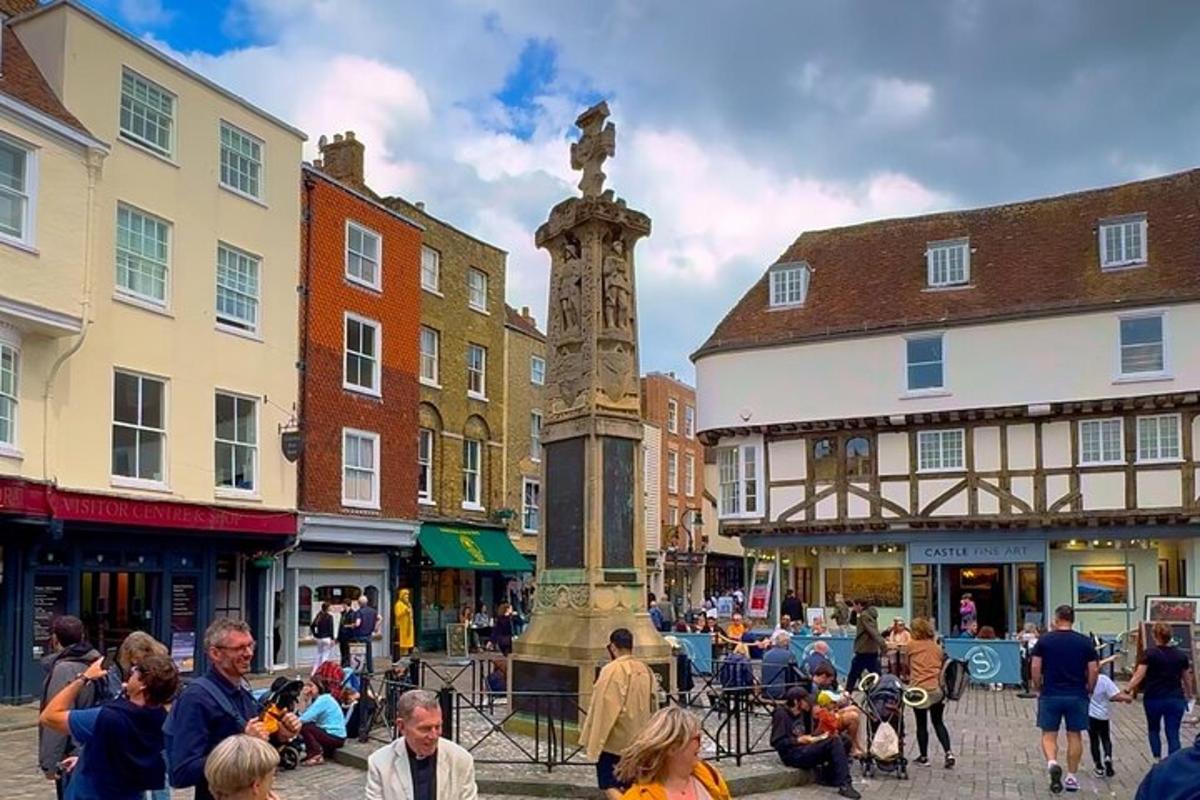 a street with a statue in the middle of a city