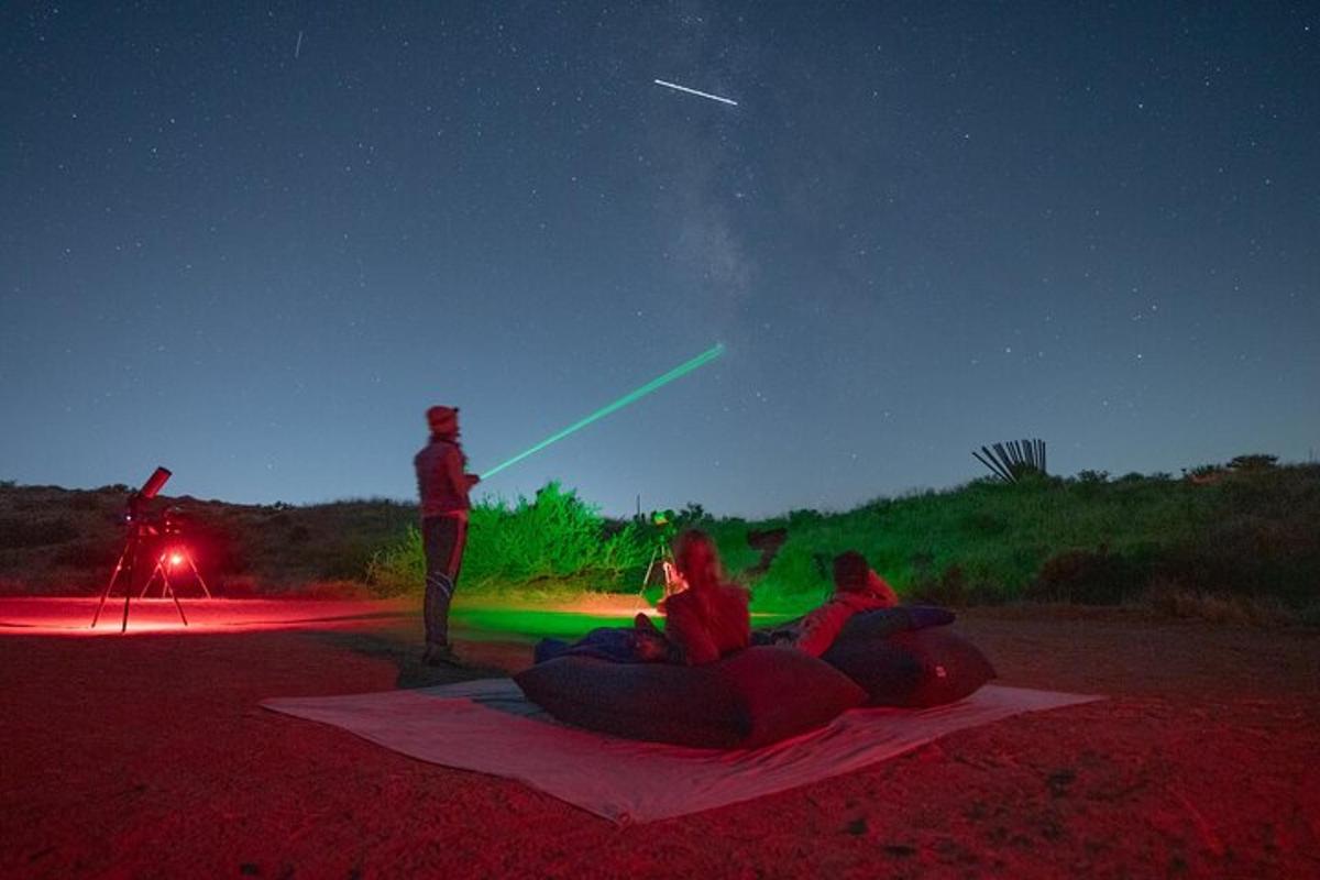 a group of people sitting on the ground at night