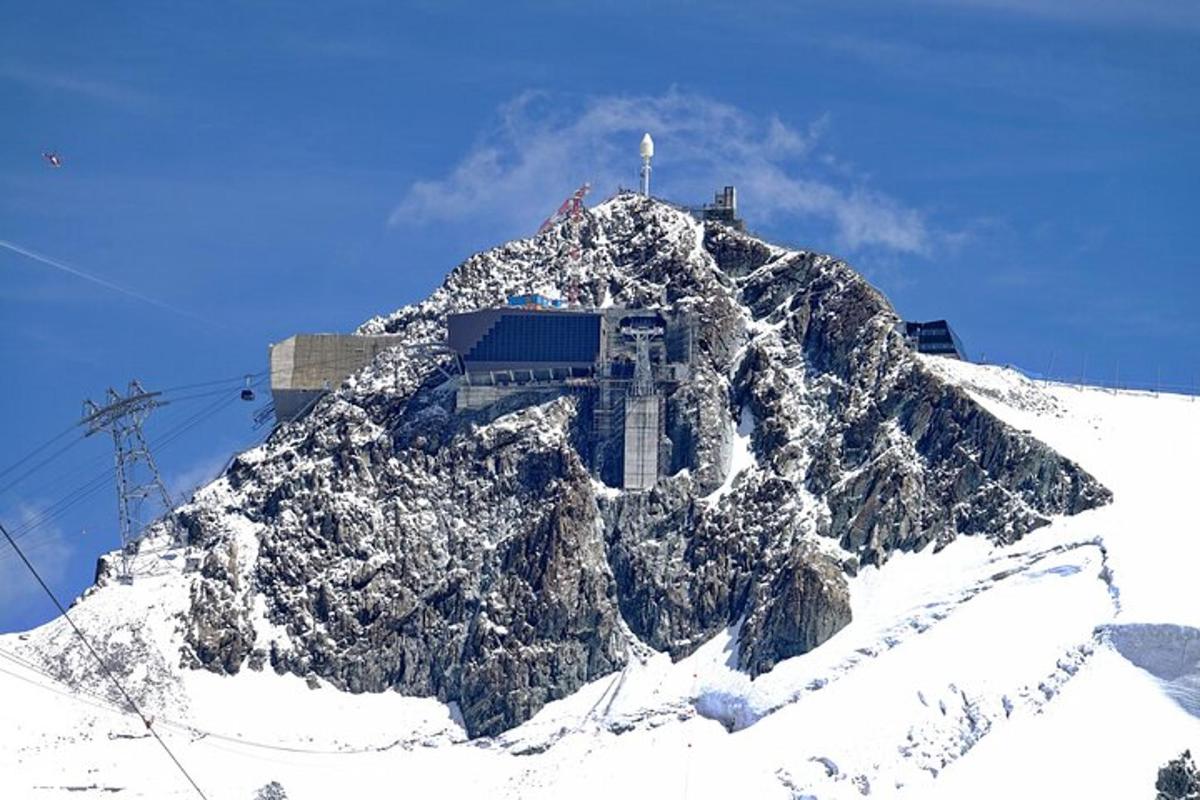 a mountain covered in snow with a building on it