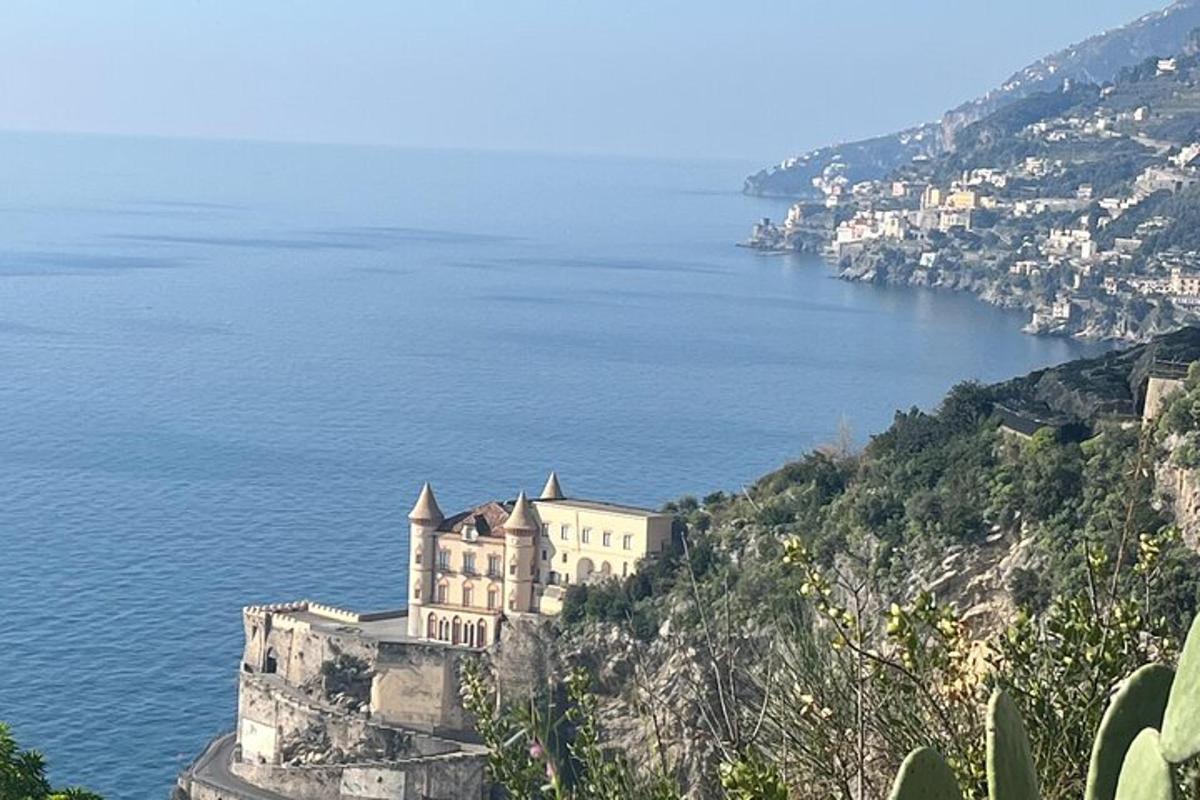 a building on a hill next to the ocean