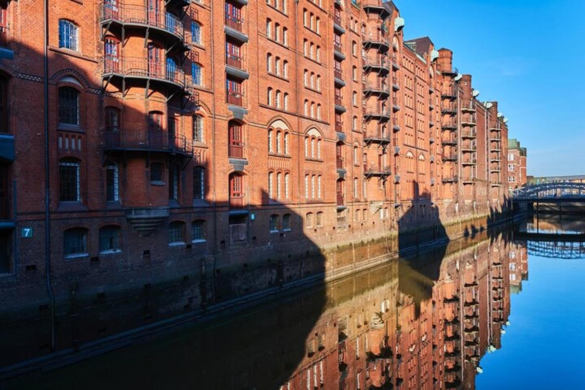 a large red brick building next to a river