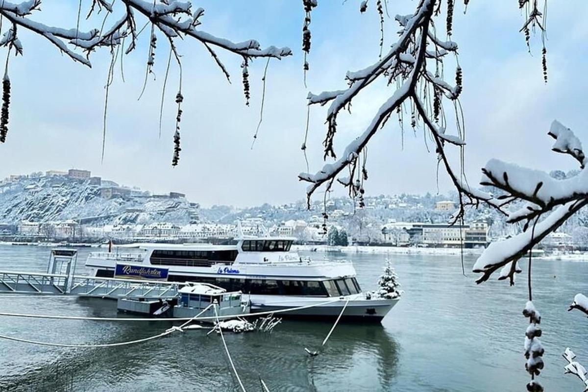two boats docked on the water with snow on them