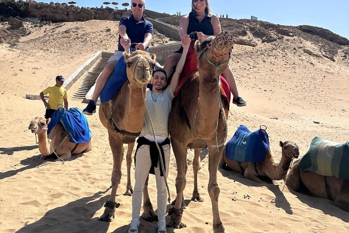 a group of people riding on camels in the desert
