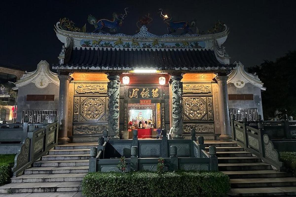 a building with a gate and stairs at night