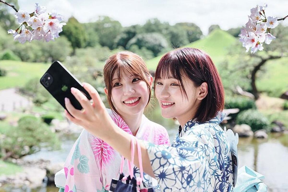 two women standing next to each other holding a cell phone