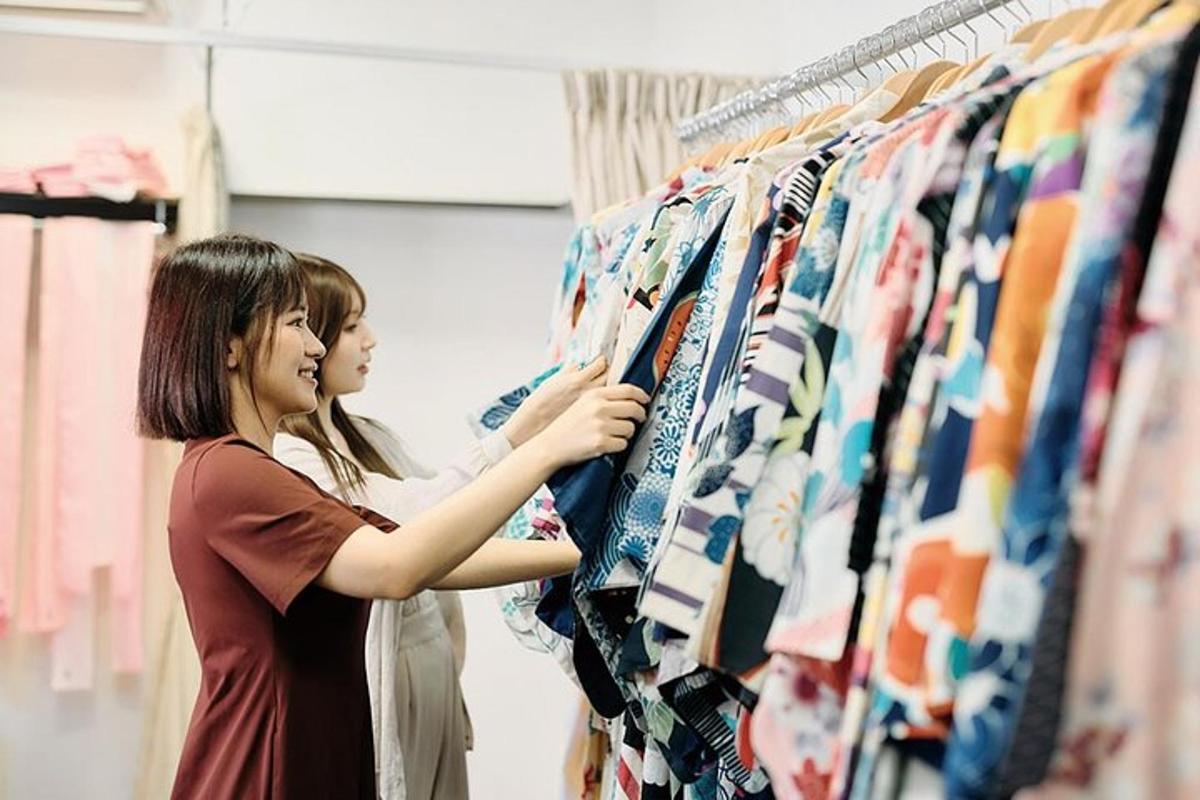 two women looking at clothes on a rack in a store