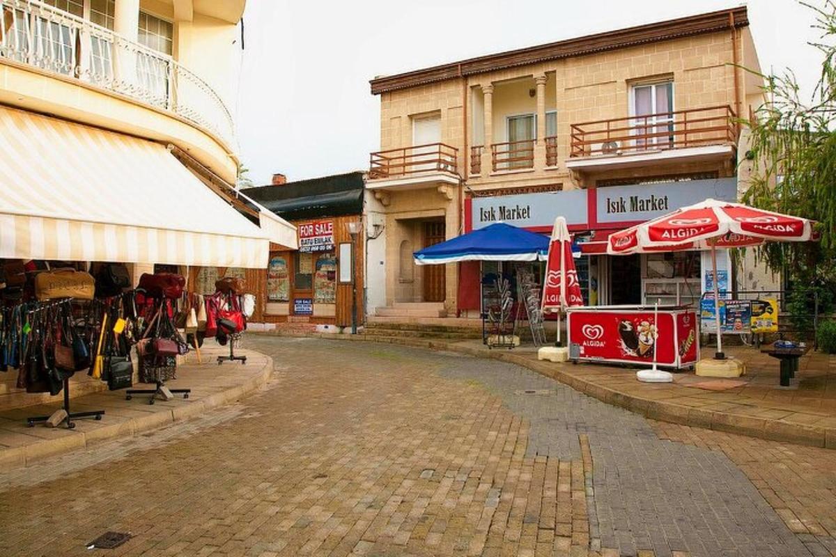 a cobblestone street in a town with shops