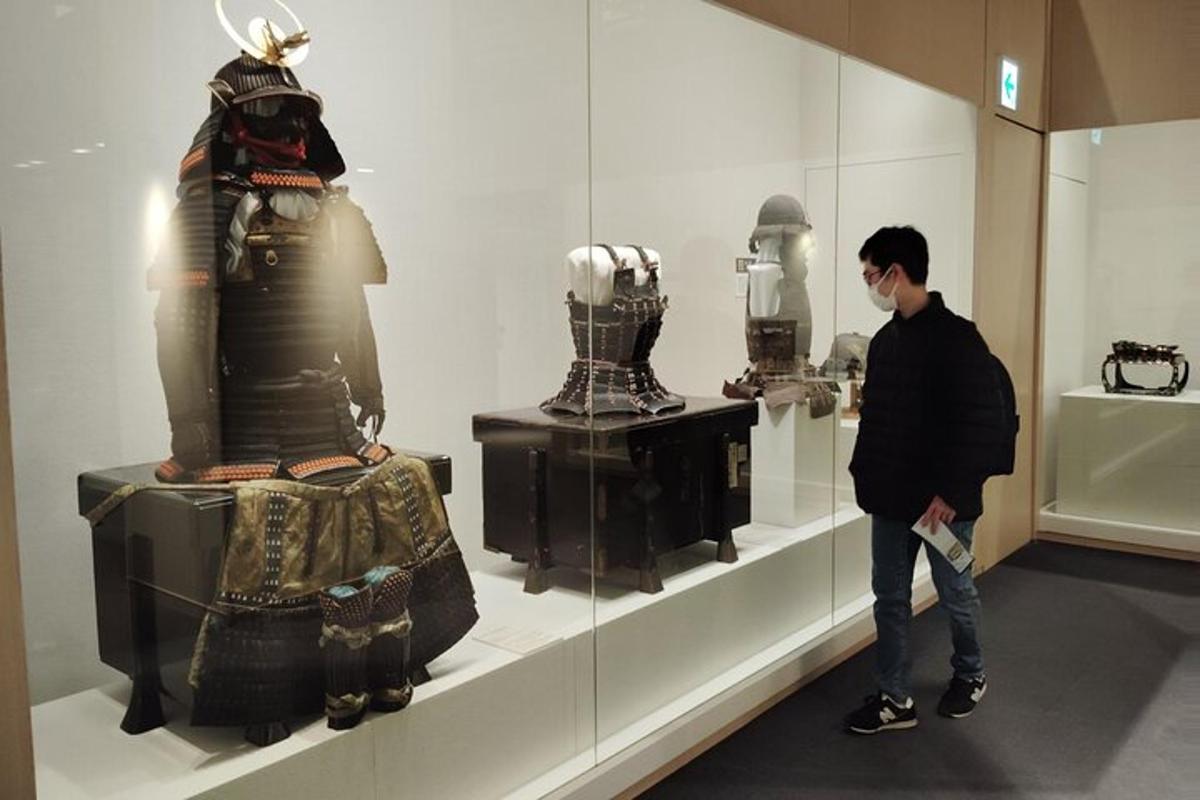 a man standing in front of a display case in a museum