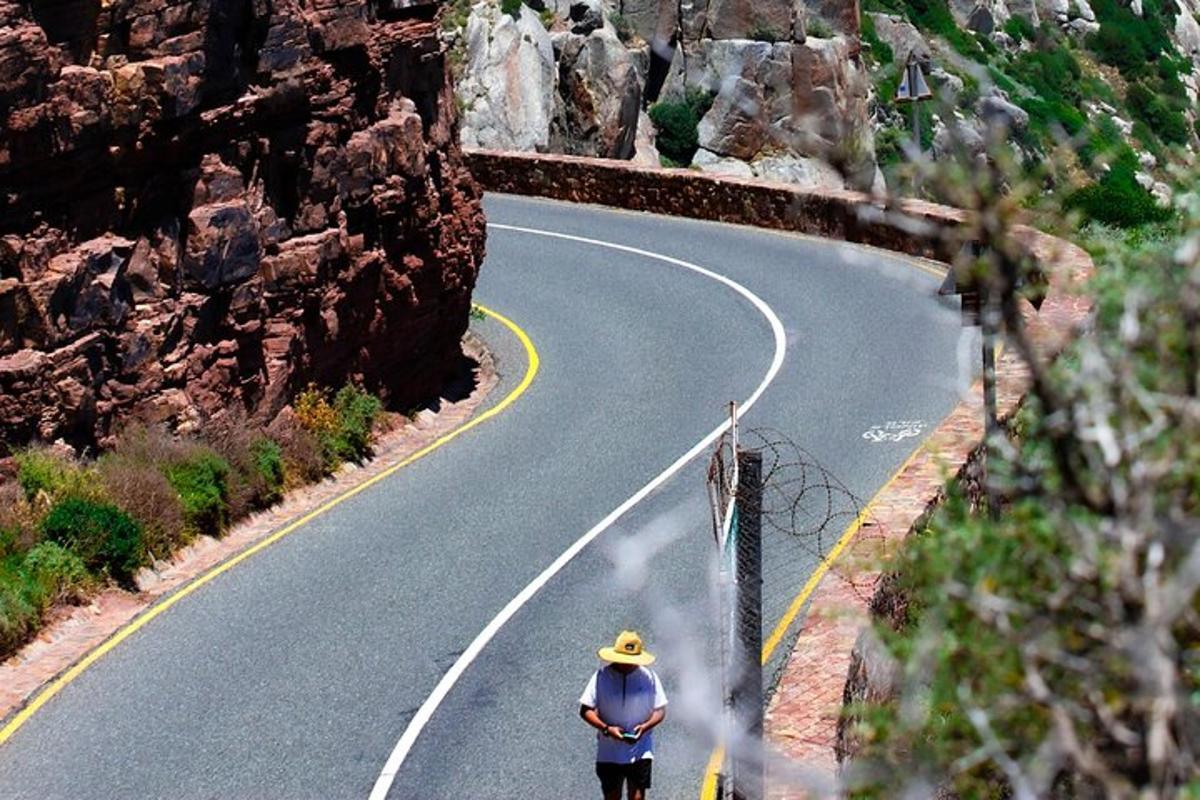 a man riding a bike down a winding road