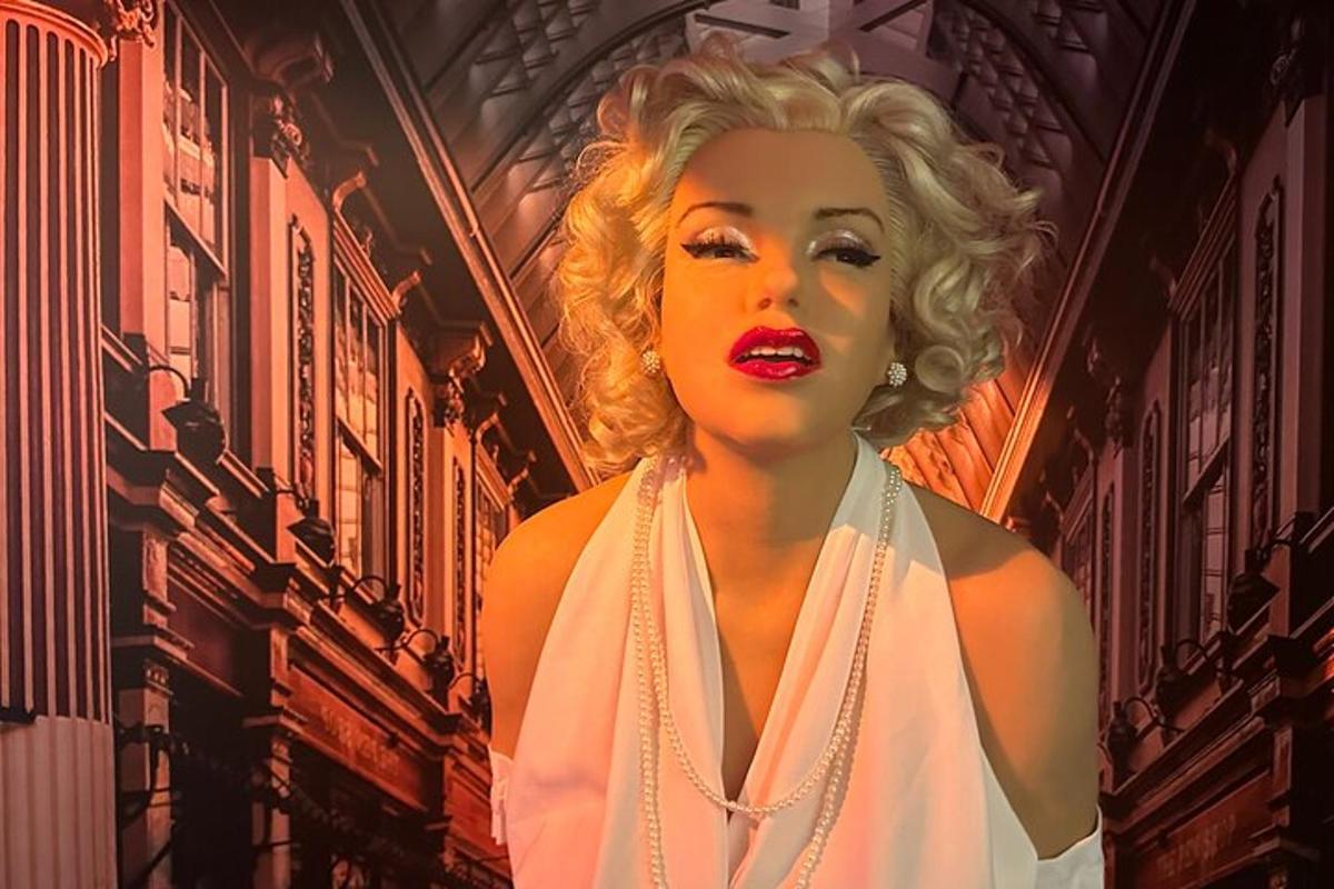 a mannequin wearing a white dress and red lipstick