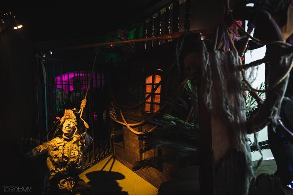a room with a statue of a man in a cage