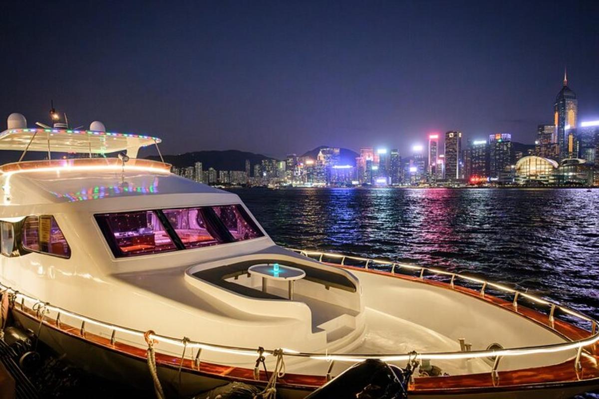a boat docked in the water with a city at night