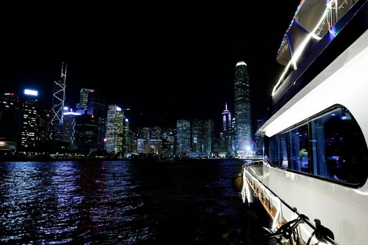 a boat on the water with a city at night