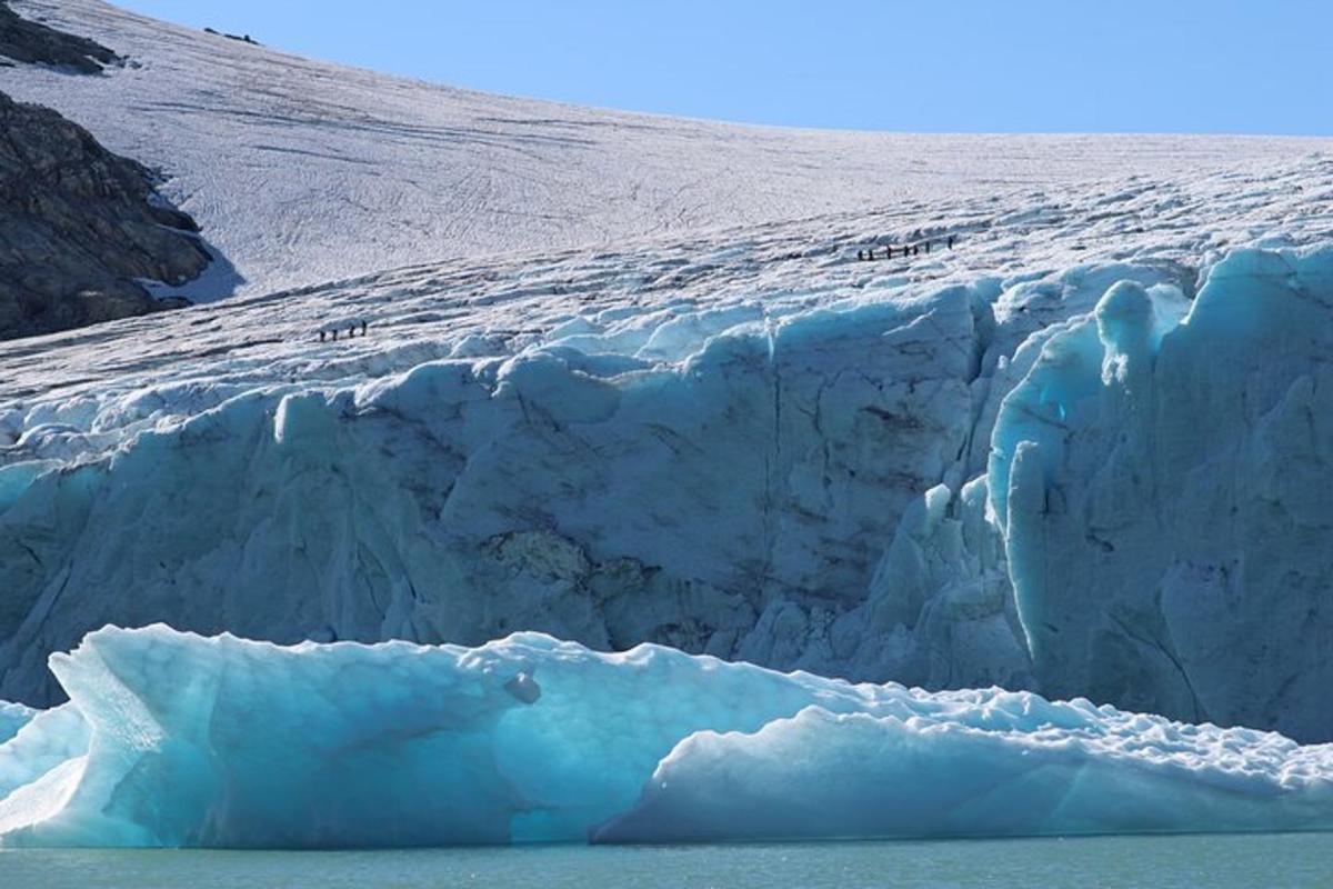 a large iceberg is in front of a glacier