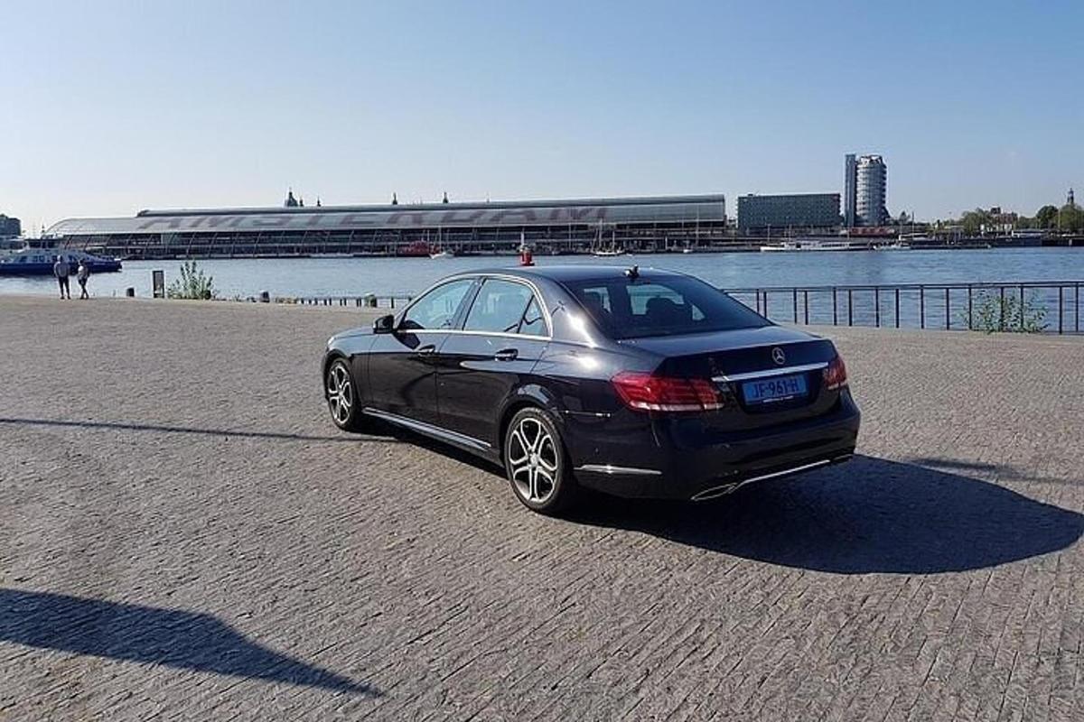 a black car parked next to a body of water
