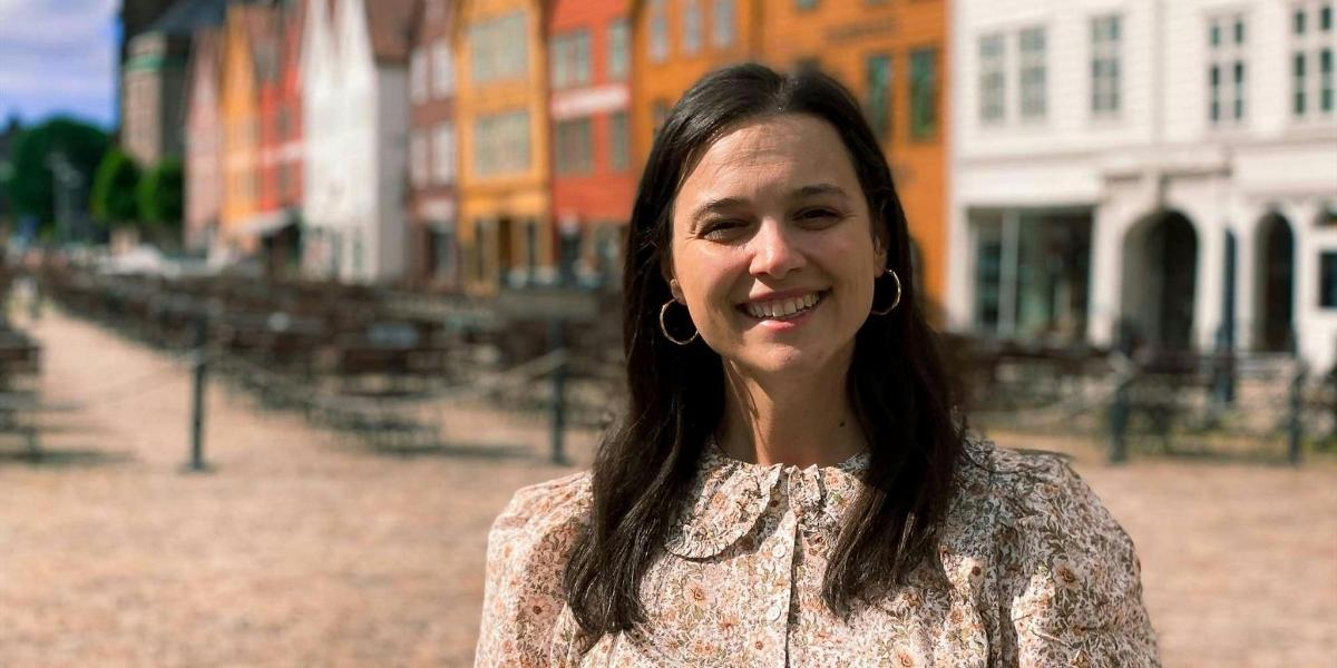 a woman is standing in front of a building