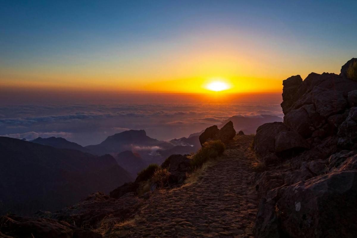 a sunset on the top of a mountain