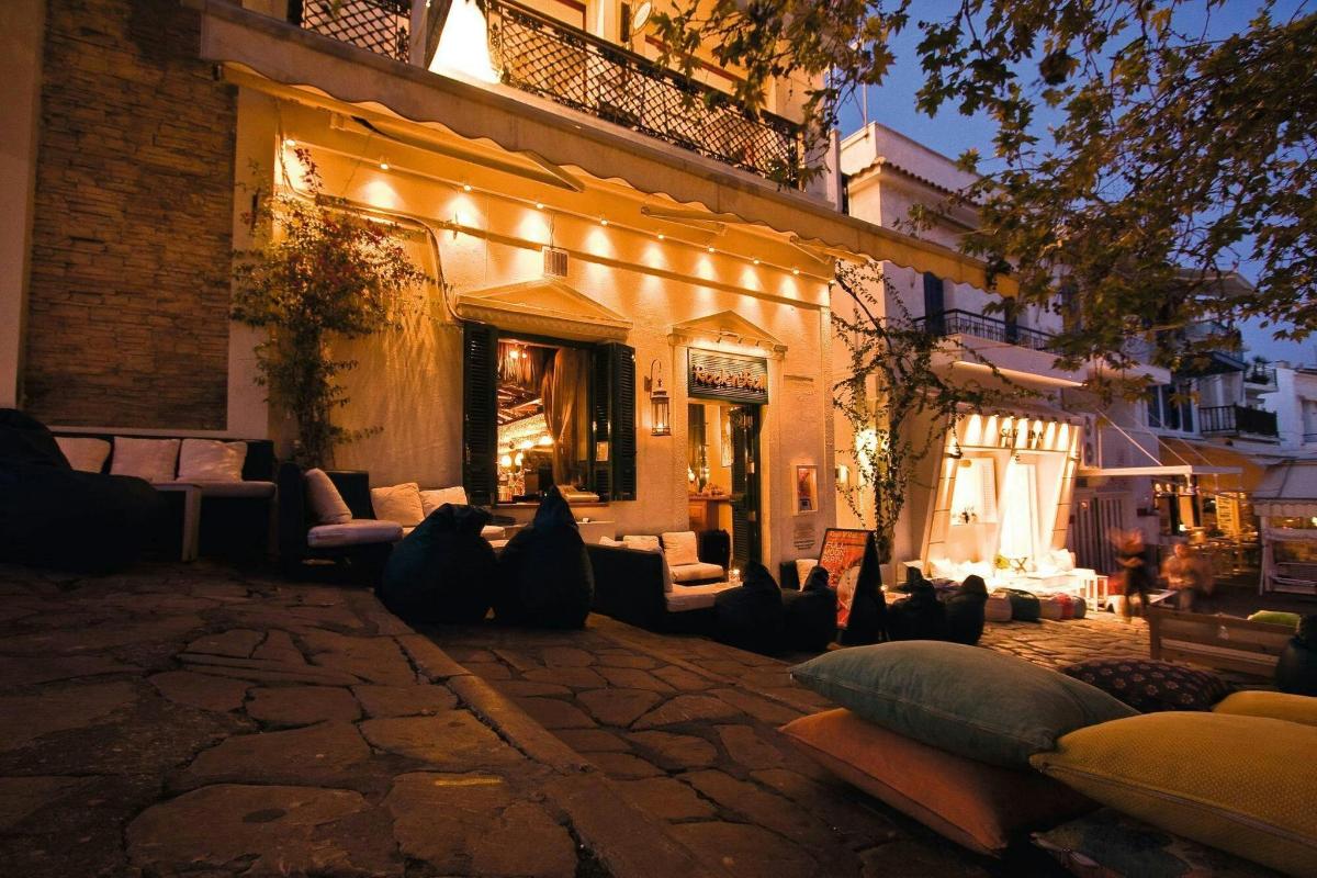 an outdoor patio with couches and chairs at night