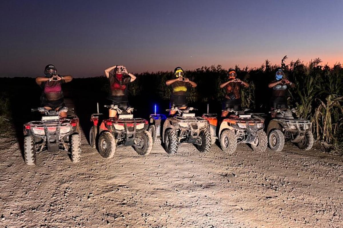 a group of people riding atvs on a dirt road