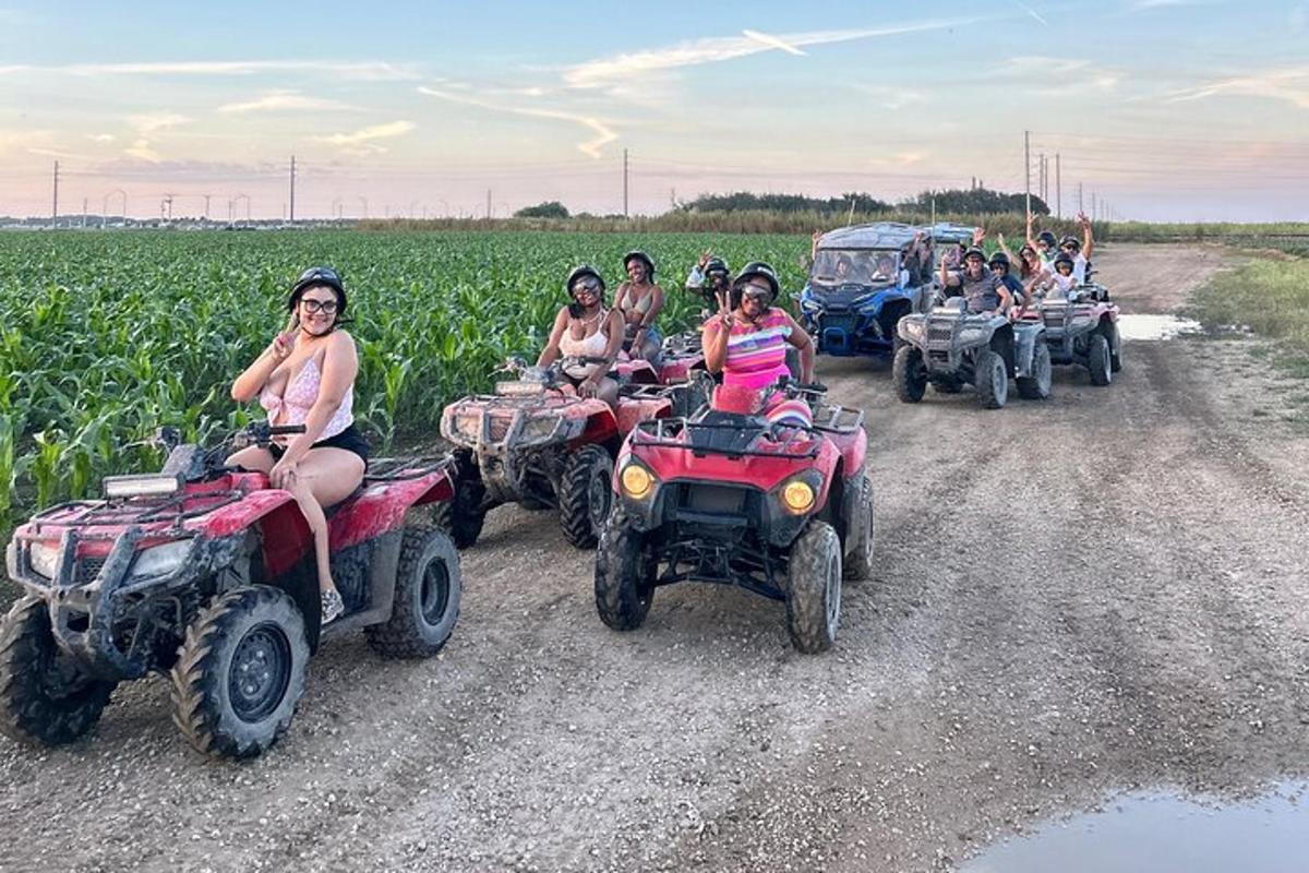 a group of people riding atvs on a dirt road