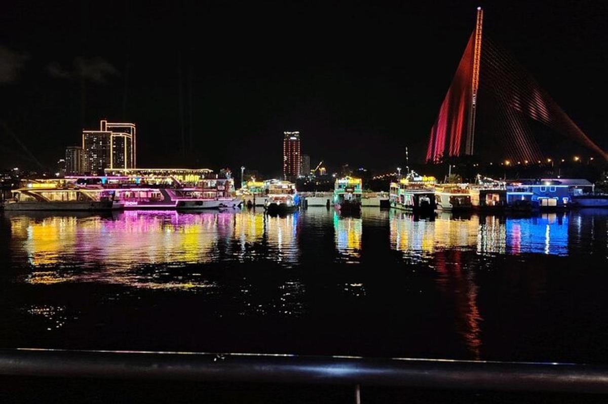 a group of boats docked in a harbor at night